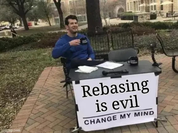 Rebasing is evil on a sign hanging from a table with a man sitting at the table drinking from a mug, popular meme.