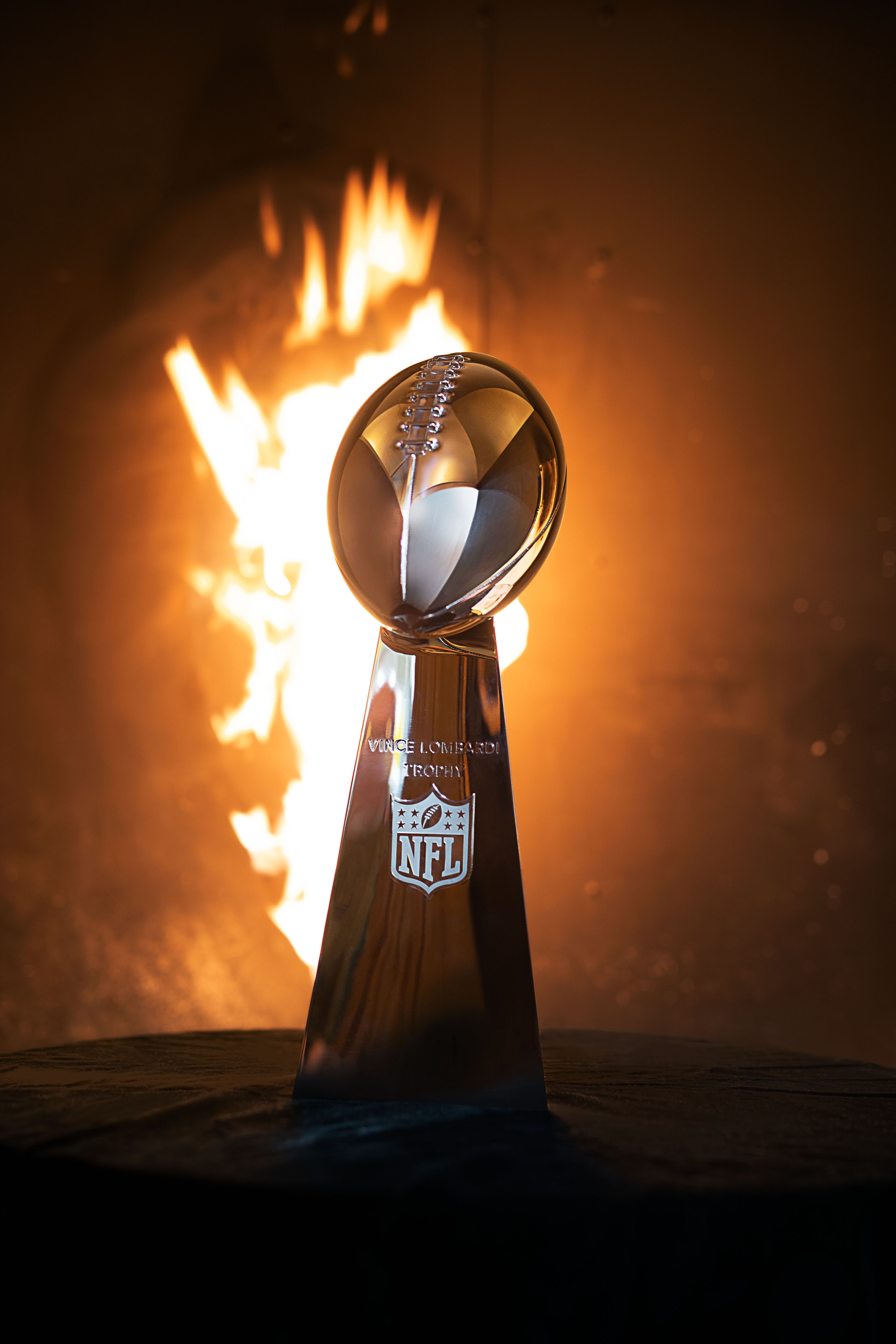 Lombardi Trophy, the trophy awarded to the winner of the National Football League's Super Bowl, in front of flames.